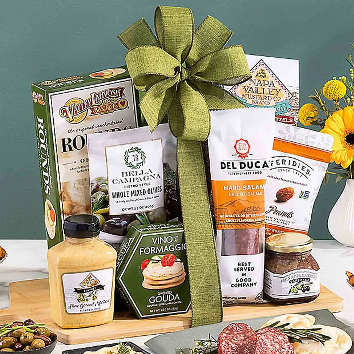 Wooden board filled with charcuterie cheese, meats, and more