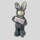 Cuddly rabbit holding sign that says 